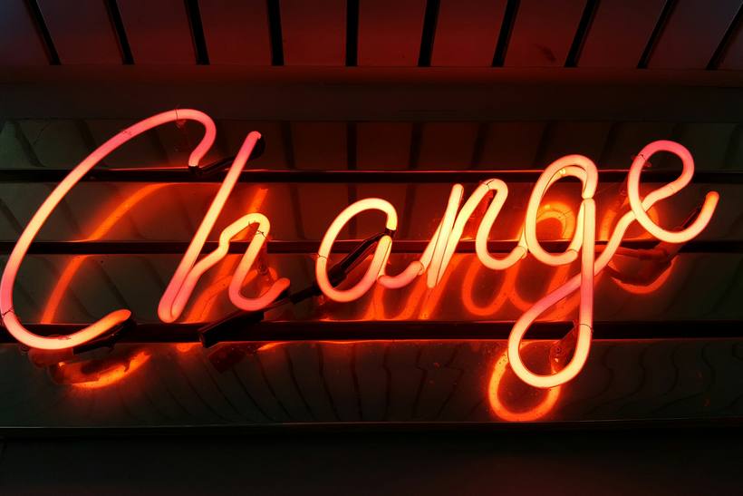 A neon sign reading Change